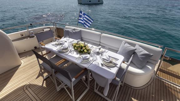 An elegant dining table with a sea view is set on the aft deck of the yacht Azure.