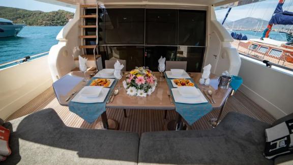 Stylishly arranged outdoor dining area of the Hurrem motor yacht offers dining pleasure with a sea view.