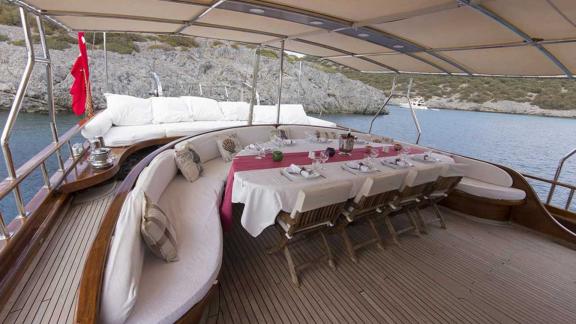 Stylishly laid table and comfortable seating in the covered dining area.