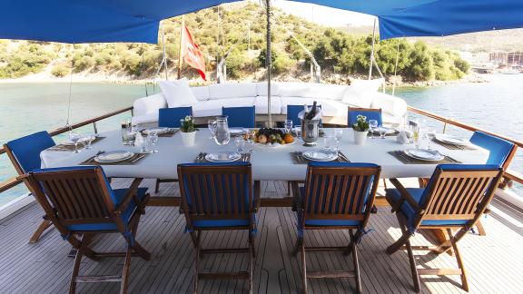 Elegantly set dining table aboard the Sunworld 8 with views of the Bodrum coast.