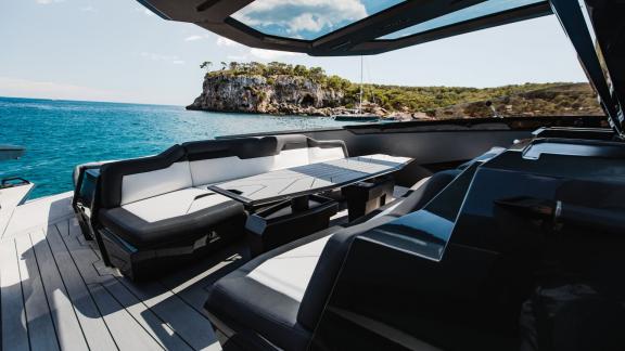 The spacious outdoor seating area on the Figo motor yacht offers peace with a sea view.