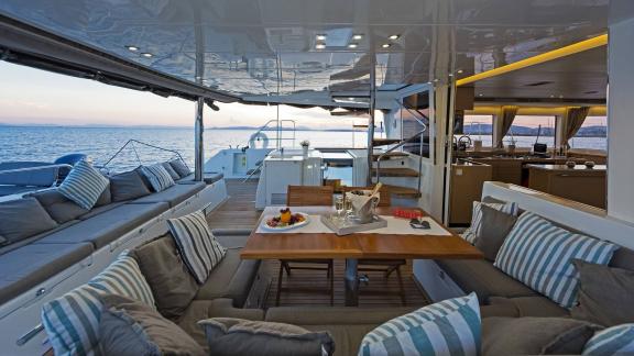 Stylish dining area on the Lagoon 560 S2 Meliti, with a view of the sea at sunset