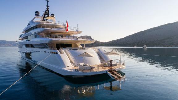 Luxury yacht Opari, elegant and modern, anchored near Greece's cliffs.