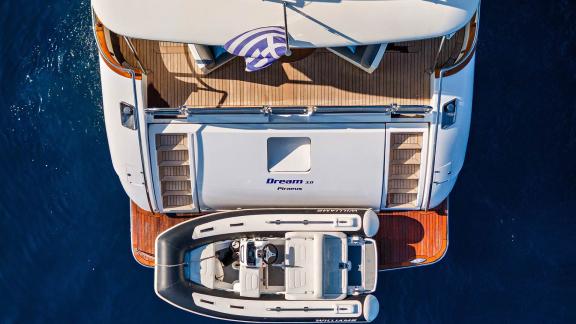 Stern view of Dream motor yacht in Athens with a tender secured to the swim platform.