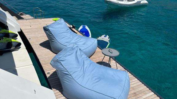 Comfortable bean bags on the water deck of Catamaran Alteya, perfect for relaxing with views of the clear blue sea.