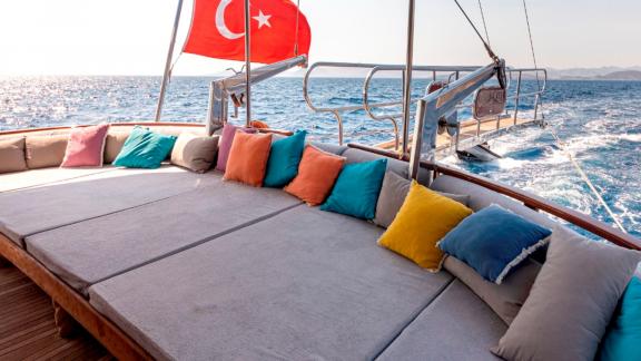 Seating area of the luxurious Gulet Bodrum Queen in Bodrum, Turkey, with colorful cushions.