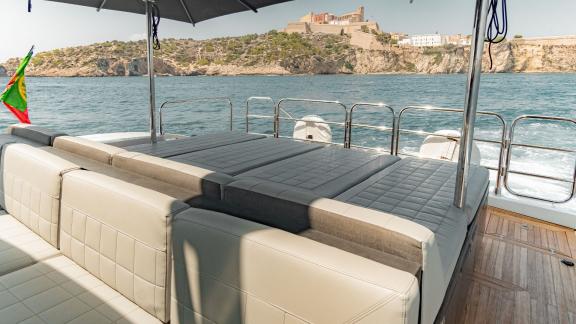 The aft deck of motor yacht La Romana features a spacious and comfortable sunbathing area.