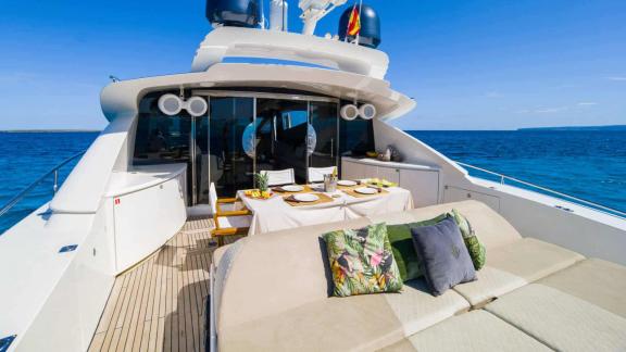 The aft deck of motor yacht Funky Town features a spacious and comfortable sunbathing area.