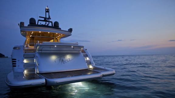 The elegantly illuminated motor yacht Thea Malta at dusk in Greece. Perfect for luxurious evenings at sea.