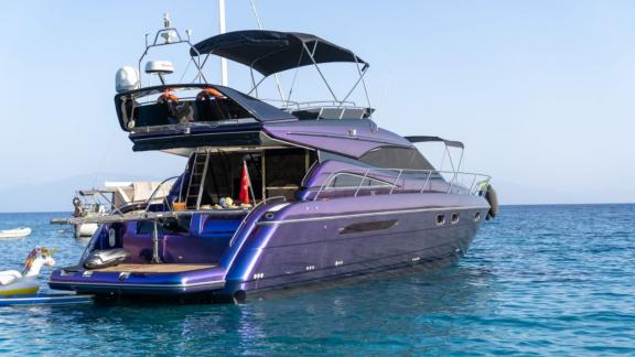 The stern of the Karan motor yacht with a spacious seating area and open sea view.