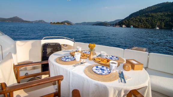 Dining area on the aft deck of motor yacht NateWhite with a view.