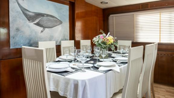 Shiva features an elegant dining salon for weekly motor yacht charters and private cruises in Mykonos.