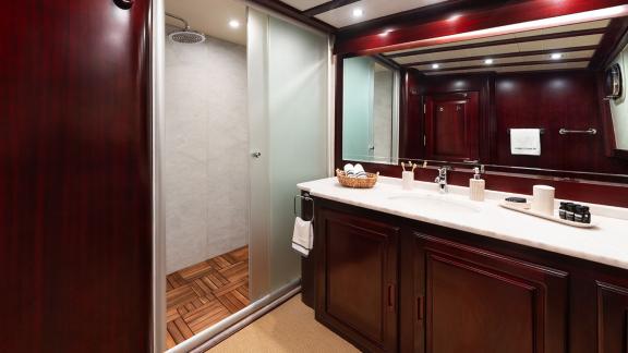 In Göcek gulet charter option Always Smile bathroom with shower cabin sink and storage area visible.