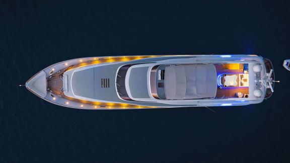 The night lighting of the Anavi motor yacht is impressively shown from an aerial perspective.