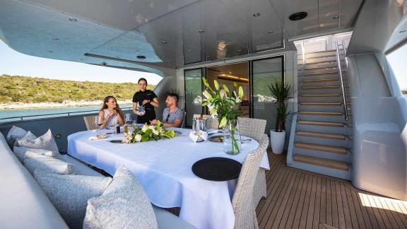 An elegant table setup for guests on the aft deck of the motor yacht Anavi.