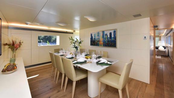 The dining area on the motor yacht Anavi offers enjoyable meals with elegant decor and comfortable chairs.