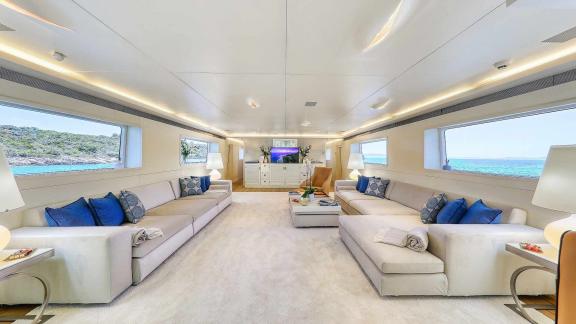 The salon of the motor yacht Anavi offers a bright atmosphere with spacious seating areas and large windows.