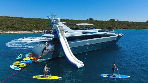 The Anavi motor yacht provides guests with fun moments using water toys like a slide and paddleboards.