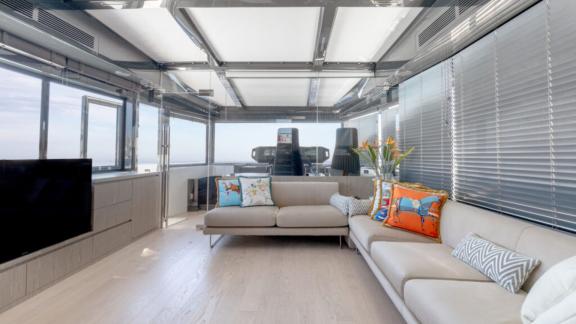 Surrounded by wide windows, the lounge features modern design and cozy seating areas.