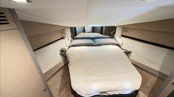 Among Saint Tropez yacht charter options Escapade motor yacht shows cabin with large double bed.