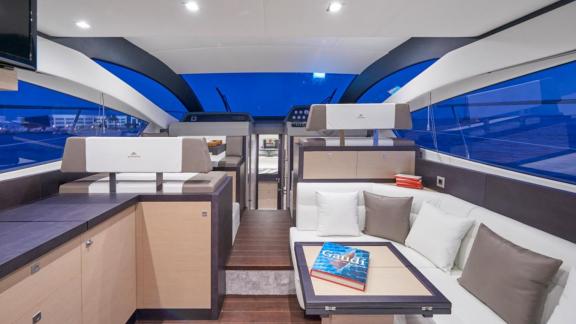 Among Saint Tropez yacht charter options Escapade motor yacht shows interior with seating and table.