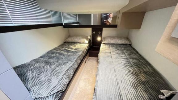 Among Saint Tropez yacht charter options Escapade motor yacht shows cabin with two single beds.