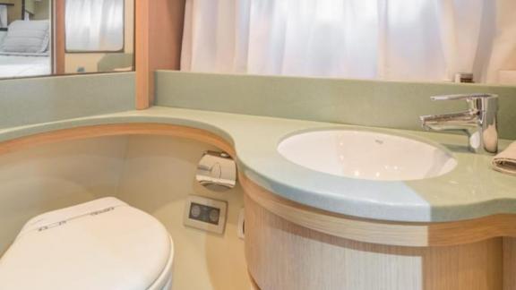 Features a sleek sink and compact toilet in a functional layout.