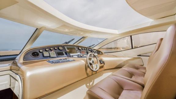 At the front of Aron 26 motor yacht, there is a modern helm station with full instrument panel.