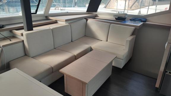 The salon area of the Reina 1 catamaran offers a spacious and comfortable living space with modern furniture.