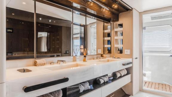 Luxury bathroom with large sink and mirror on Nemesis yacht, spacious and modern design.