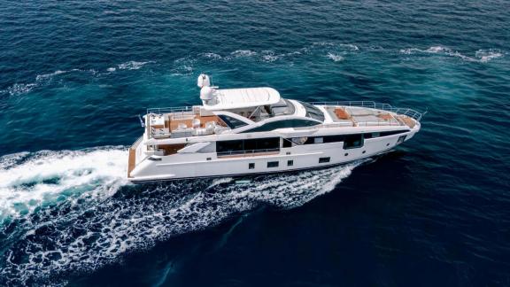 Spacious deck and stylish motor yacht cruising in Mallorca waters.