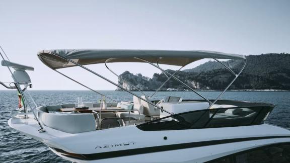 Leeloo yacht’s flybridge features a spacious seating area with a bimini top.