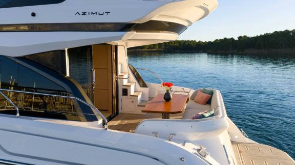 In Sibenik motor yacht charter option Nalu aft deck with table and seating area offering relaxing moments with sea view
