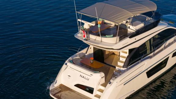 In Sibenik motor yacht charter option Nalu aft deck with seating and upper deck access offering comfortable holiday expe