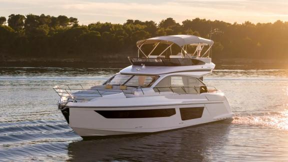 In Sibenik motor yacht charter option Nalu cruising at sunset on calm waters offering luxury and relaxing experience vis