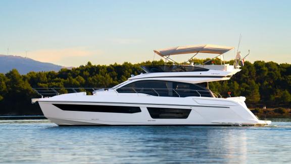 In Sibenik motor yacht charter option Nalu on calm sea with modern design and spacious layout offering comfort visible.