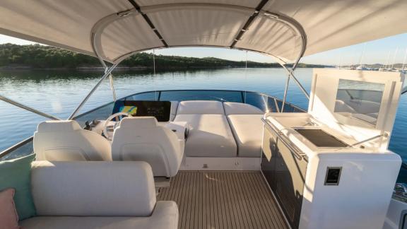 In Sibenik motor yacht charter option Nalu upper deck with helm and seating area offering smooth and comfortable cruisin