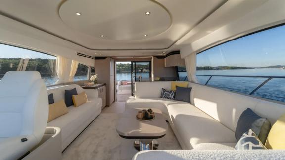 In Sibenik motor yacht charter option Nalu salon with large sofas and sea view offering spacious and comfortable living