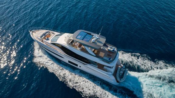 Die Viva mit Flybridge und Heckplattform gleitet stilvoll durch das blaue Wasser.