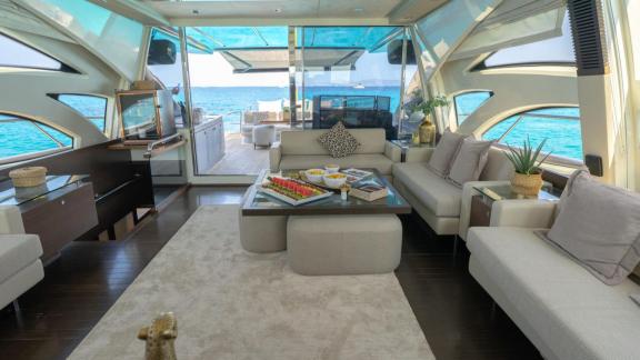 The Jungle motor yacht is anchored in Ibiza, featuring a spacious salon and sea view lounge area.