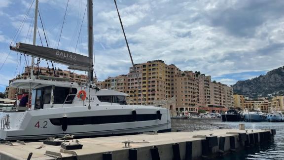 The Bali 4.2 catamaran named Christeol is tied up at the dock in the scenic Monaco harbour.