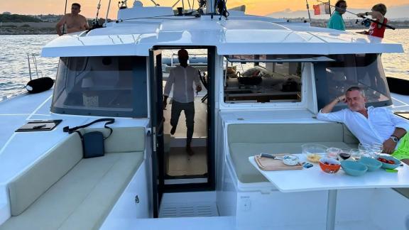 A peaceful sunset moment on the foredeck of Bali 4.2 Christeol catamaran, surrounded by the sea.