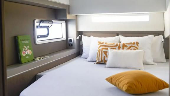 A bright and modern guest cabin aboard the Christeol catamaran offers a comfortable place to relax.