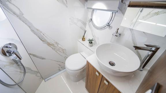 Stylish bathroom on the Panta Rei motor yacht with elegant marble accents and luxurious amenities.