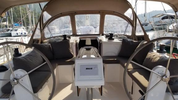 The helm area of the sailboat Fiesta is shown with comfortable seating areas.