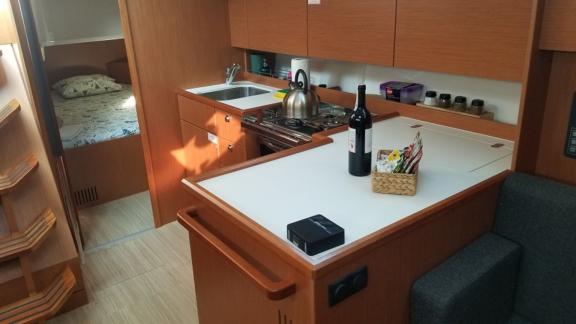 The kitchen area of the sailboat Fiesta is shown with a stove, oven, and spacious countertop.