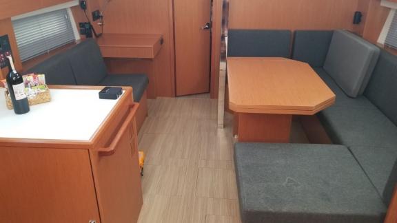 The salon area of the sailboat Fiesta is shown with comfortable seating and a table.