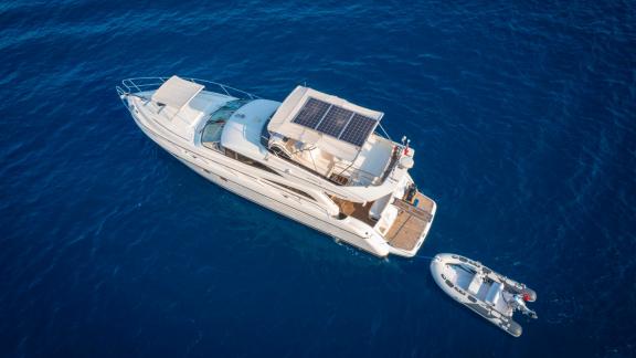 Aerial view of motor yacht NateWhite, with a dinghy beside it.