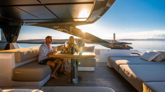 Motor yacht Kimani Bluegame BG74 features a stylish aft deck lounge area set for breathtaking sea journeys.