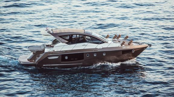 Motor yacht Brown Sugar cruising off the coast of Croatia. Its luxurious design and modern structure stand out.